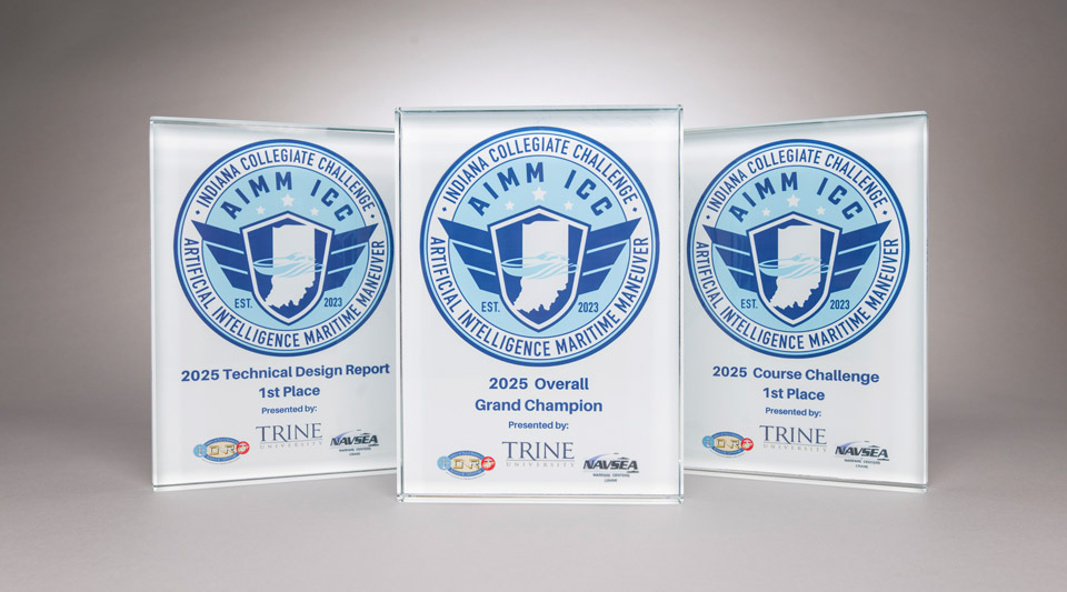 Three awards with blue designs on a light gray background
