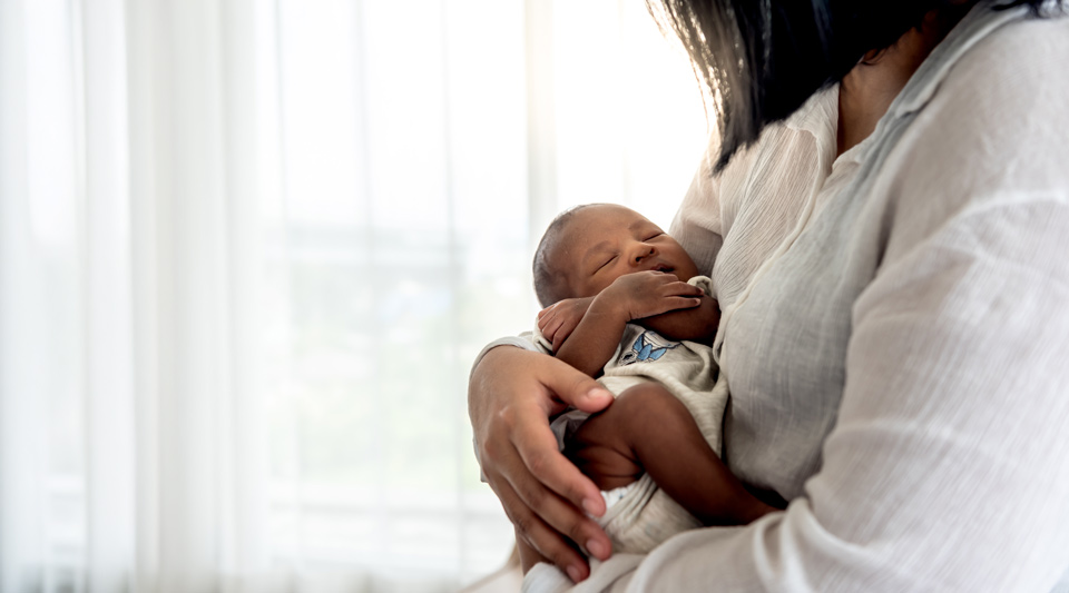 A mother holds a newborn baby