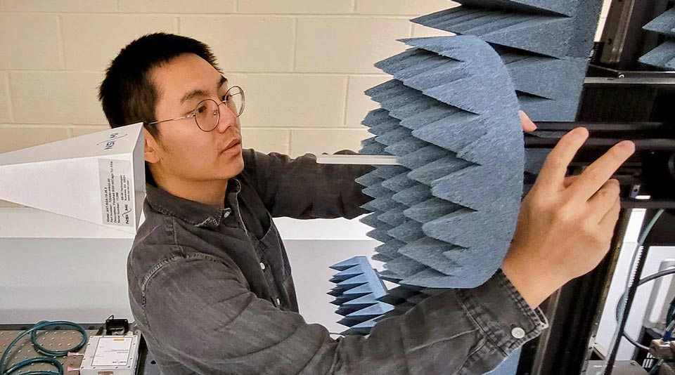 Wei Wang adjusting lab instrument