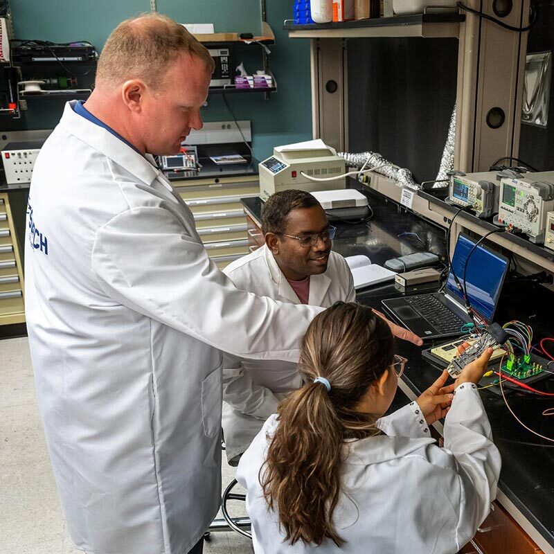 Professor Tom O'Sullivan working on NearWave technology with graduate students in his lab