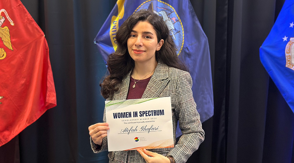 Atefah Ghafari poses with her Women in Spectrum certificate